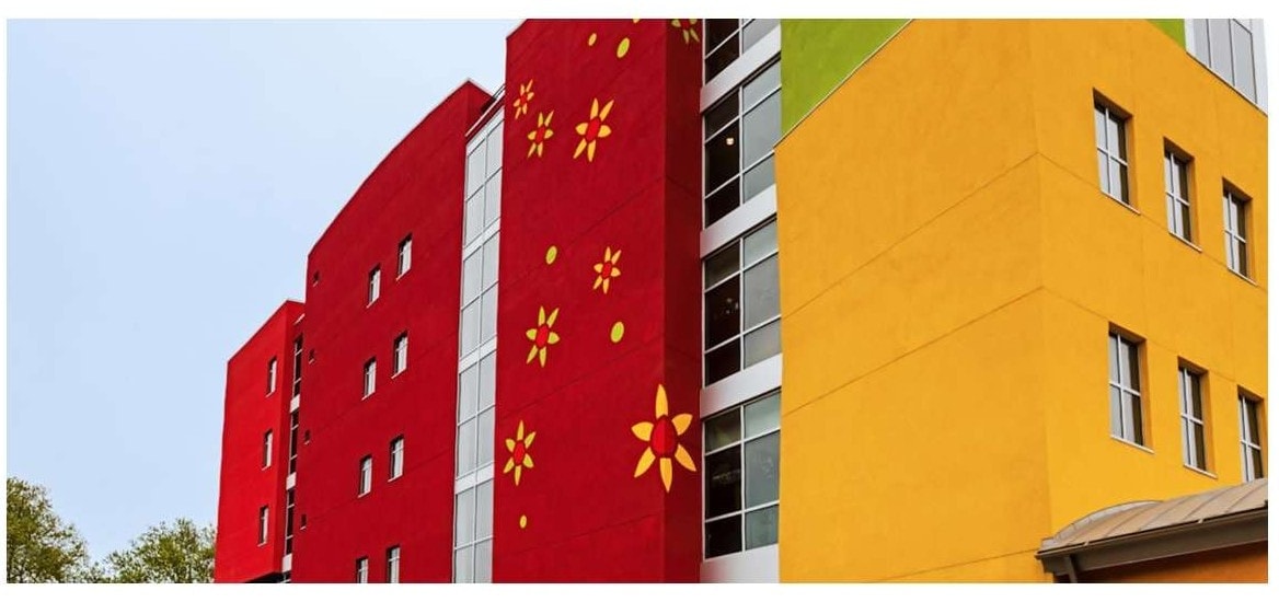 South Bronx School for International Cultural and Arts exterior stucco wide view